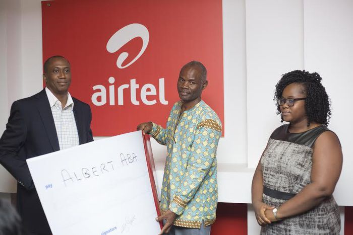 Solanke Abimbola, Finance Director- Airtel Ghana making the presentation to Mr. Gershon Aba, uncle of Albert Aba.