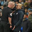 Referee Anthony Taylor has words with Manchester City manager Pep Guardiola