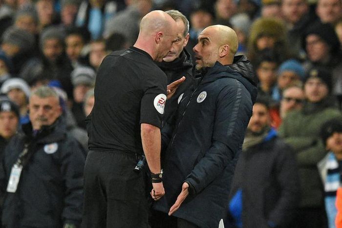 Referee Anthony Taylor has words with Manchester City manager Pep Guardiola