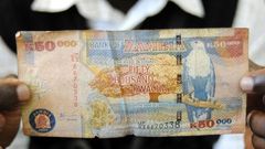 A man displays a 50,000 Kwacha note in Lusaka January 23, 2012.  REUTERS/Mackson Wasamunu