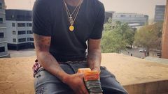 Davido with a stack of Rands