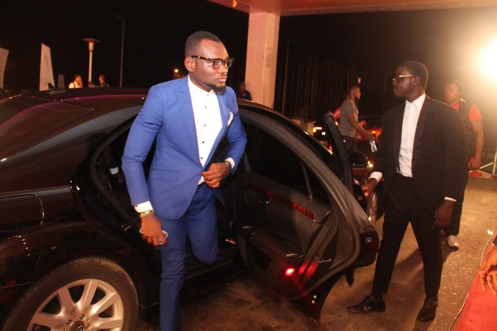 Prince David Osei stepping from a luxurious car