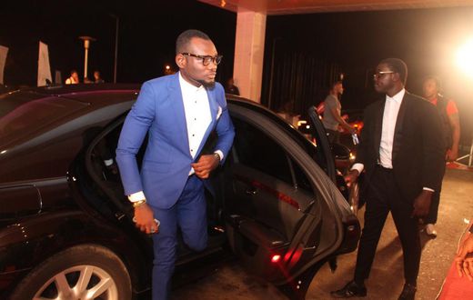 Prince David Osei stepping from a luxurious car