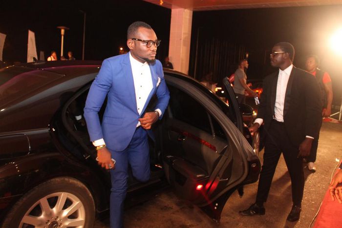 Prince David Osei stepping from a luxurious car