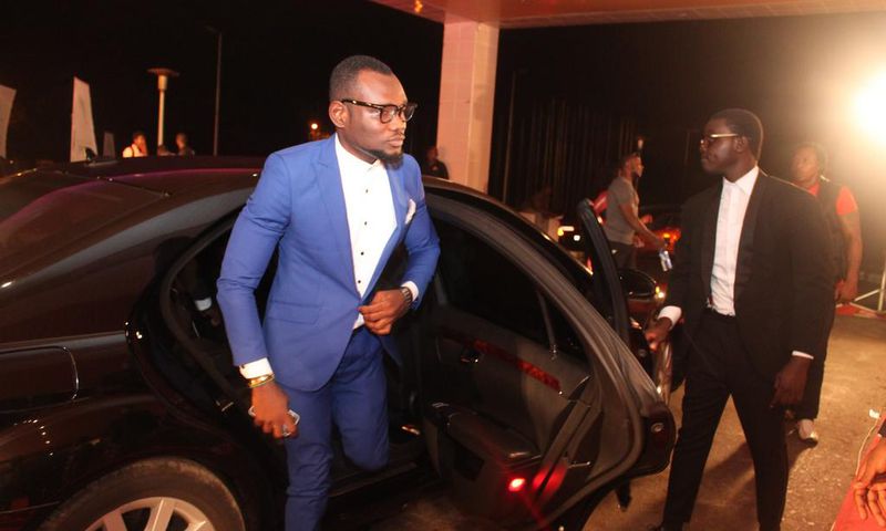 Prince David Osei stepping from a luxurious car