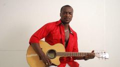 Highlife artiste, Kwabena Kwabena with his guitar