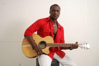Highlife artiste, Kwabena Kwabena with his guitar