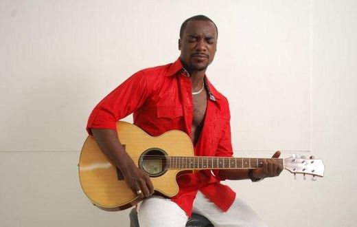 Highlife artiste, Kwabena Kwabena with his guitar