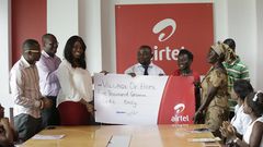 Hilary Denise Arko-Dadzie (3rd from left), from Airtel Ghana making the presentation to Mr. Kwaku Sarkodie, representative of Village of Hope Orphanage