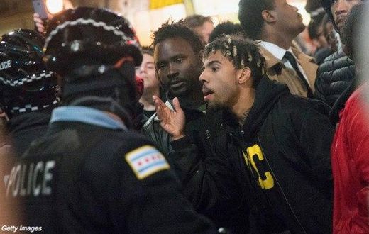 Rapper Vic Mensa confronts police during the protest