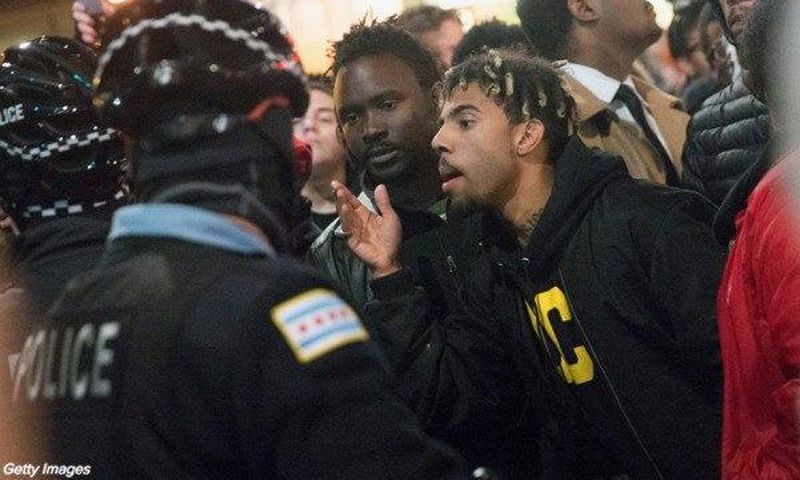 Rapper Vic Mensa confronts police during the protest