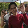 Myanmar pro-democracy leader Aung San Suu Kyi waves at supporters as she visits polling stations at her constituency Kawhmu township November 8, 2015.