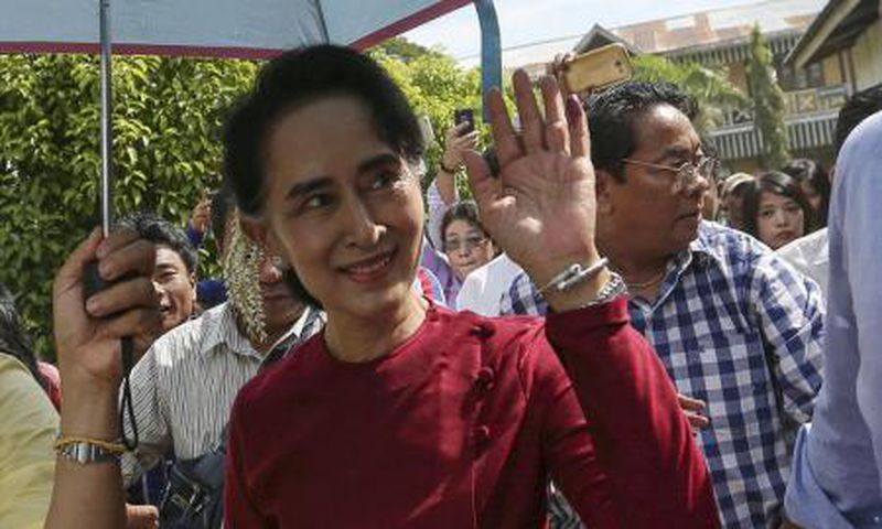 Myanmar pro-democracy leader Aung San Suu Kyi waves at supporters as she visits polling stations at her constituency Kawhmu township November 8, 2015.