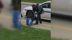Picture of Black police officer tying boy’s shoe goes viral