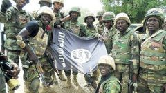 Nigerians soldiers destroy Boko Haram flag.