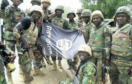 Nigerians soldiers destroy Boko Haram flag.