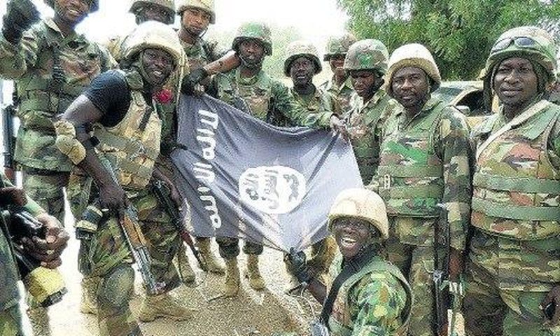 Nigerians soldiers destroy Boko Haram flag.