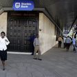 Kenyan city residents walk past Stanbic Bank in the capital Nairobi  in a file photo.  REUTERS/Antony Njuguna