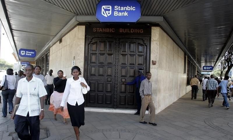 Kenyan city residents walk past Stanbic Bank in the capital Nairobi  in a file photo.  REUTERS/Antony Njuguna