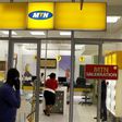 A man speaks on a mobile phone as he walks past a MTN shop at a shopping mall south of Johannesburg June 6, 2012. REUTERS/Siphiwe Sibeko