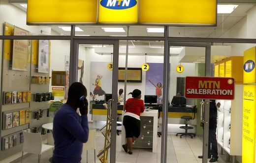 A man speaks on a mobile phone as he walks past a MTN shop at a shopping mall south of Johannesburg June 6, 2012.     REUTERS/Siphiwe Sibeko