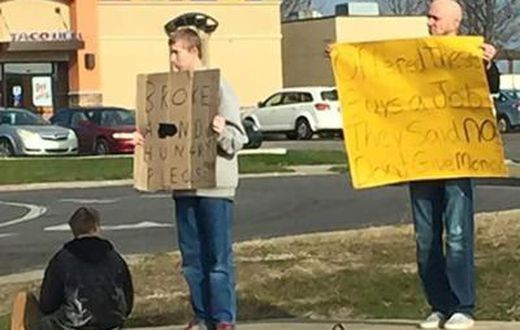 Mike Pothoff beside the panhandlers holding his sign