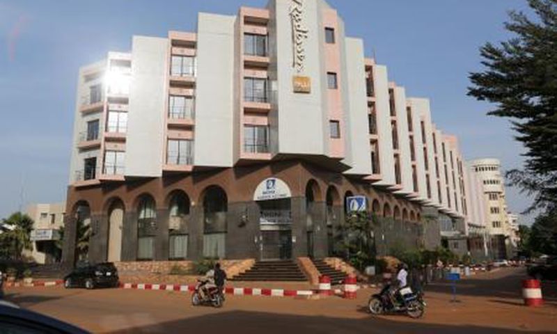 People drive motorcycles past the Radisson Blu hotel in Bamako, Mali, November 22, 2015.