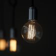 A bulb hangs inside a restaurant in Madrid December 23, 2013. REUTERS/Andrea Comas