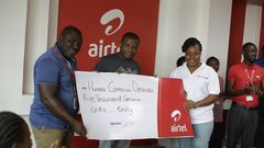 Maruf Lawal, Networks & IT Director (middle) assisted by Kwame Annor (Left) – Human Resource Business Partner, Airtel to make the presentation  to Ms. Angela Jones (Right), representative of the Orphanage