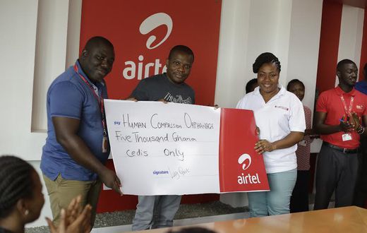 Maruf Lawal, Networks & IT Director (middle) assisted by Kwame Annor (Left) – Human Resource Business Partner, Airtel to make the presentation  to Ms. Angela Jones (Right), representative of the Orphanage
