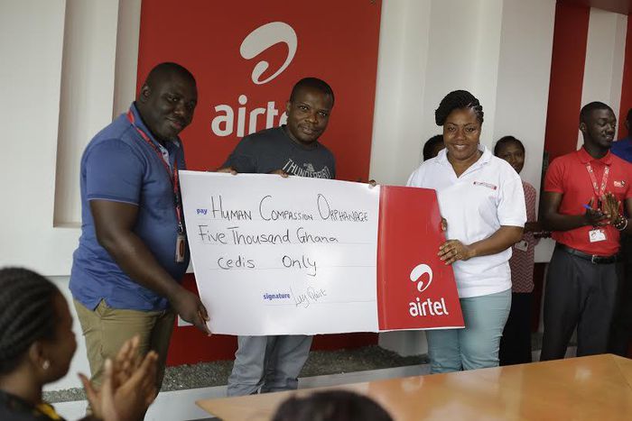 Maruf Lawal, Networks & IT Director (middle) assisted by Kwame Annor (Left) – Human Resource Business Partner, Airtel to make the presentation  to Ms. Angela Jones (Right), representative of the Orphanage