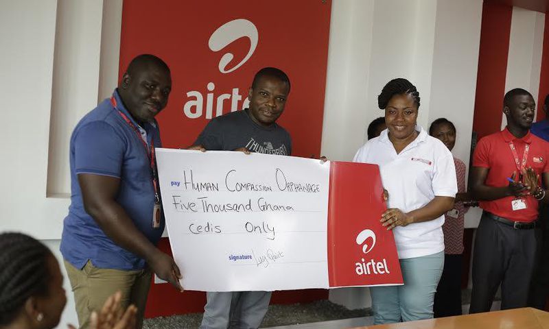Maruf Lawal, Networks & IT Director (middle) assisted by Kwame Annor (Left) – Human Resource Business Partner, Airtel to make the presentation  to Ms. Angela Jones (Right), representative of the Orphanage