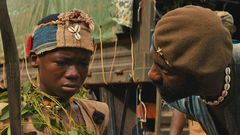 A scene from the movie [Abraham Attah and Idris Elba]