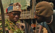 A scene from the movie [Abraham Attah and Idris Elba]