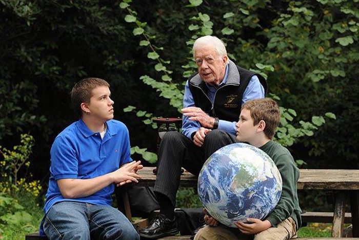 Jimmy Carter walks with his grandsons Jeremy Carter (R), 22, and Hugo Wentzel, 10 during a picnic event on October 31, 2009 in Istanbul, Turkey