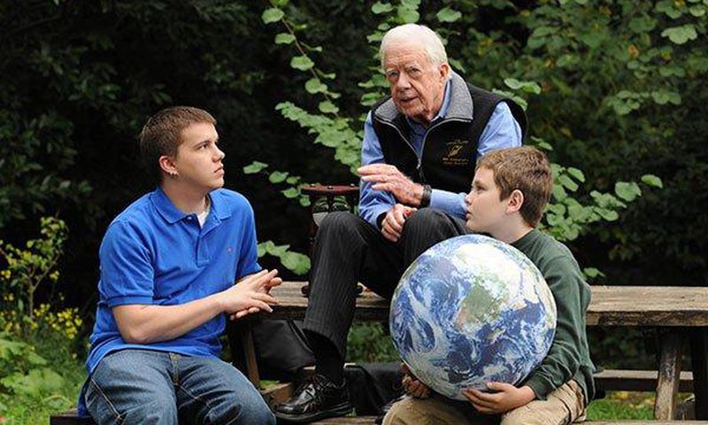 Jimmy Carter walks with his grandsons Jeremy Carter (R), 22, and Hugo Wentzel, 10 during a picnic event on October 31, 2009 in Istanbul, Turkey