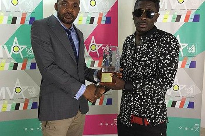 Shatta Wale receiving his 4syte Music Video award during the presentation.