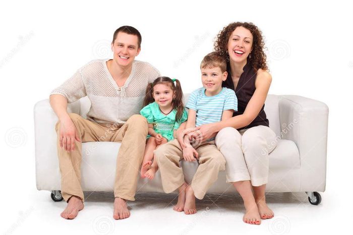 Family sitting on white leather sofa