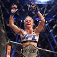 Holly Holm celebrates with her UFC belt after beating Ronda Rousey