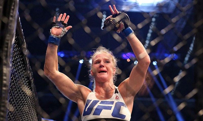 Holly Holm celebrates with her UFC belt after beating Ronda Rousey