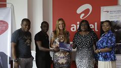 Maruf Lawal (Left), Frank Djan (2nd from left) from Airtel presents the ticket to Anas Khalid Hadi (middle), winner of the promo. With them are Mandy Johnson (2nd from right) and Georgina Acquaye (right) from British Airways.