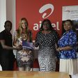 Maruf Lawal (Left), Frank Djan (2nd from left) from Airtel presents the ticket to Anas Khalid Hadi (middle), winner of the promo. With them are Mandy Johnson (2nd from right) and Georgina Acquaye (right) from British Airways.
