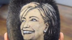 Maria Anita Monsivaiz shaves the face of Hillary Clinton on to her head