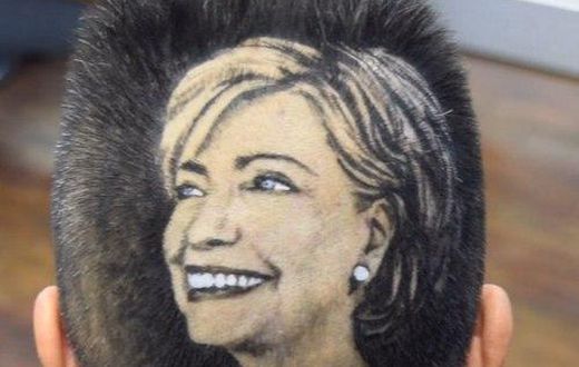 Maria Anita Monsivaiz shaves the face of Hillary Clinton on to her head