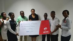 Hannah Agbozo, Legal & Corporate Affairs Director (Middle) and Maruf Lawal, Networks& IT Director (3rd from Left) making the presentation to Mr. Francis Abotsi (2nd from right)