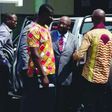 Pastor (in suit) arraigned before court for stealing power