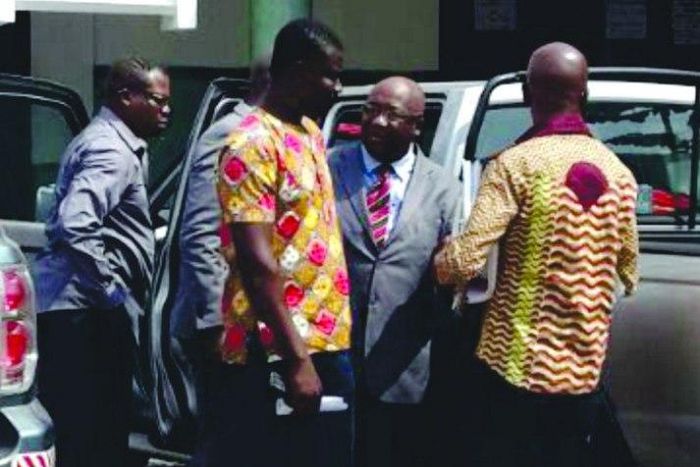 Pastor (in suit) arraigned before court for stealing power