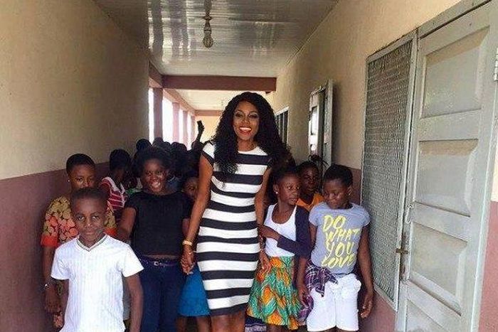 Yvonne Nelson and some pupils of St. Martin De Porres Schoo