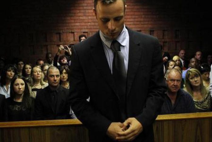 Oscar Pistorius stands in the dock ahead of court proceedings at the Pretoria magistrates court February 22, 2013.