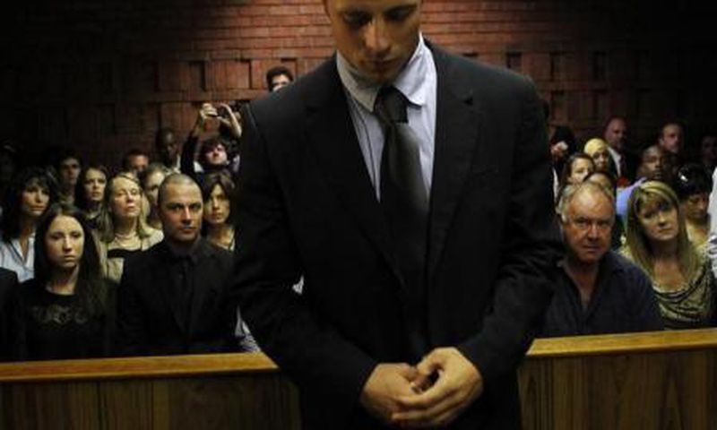 Oscar Pistorius stands in the dock ahead of court proceedings at the Pretoria magistrates court February 22, 2013.